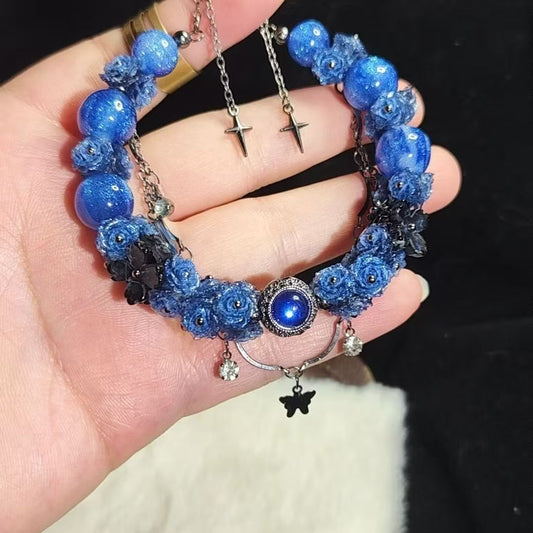 # hand - crafted with a cord, features light blue beads and colorful ornaments