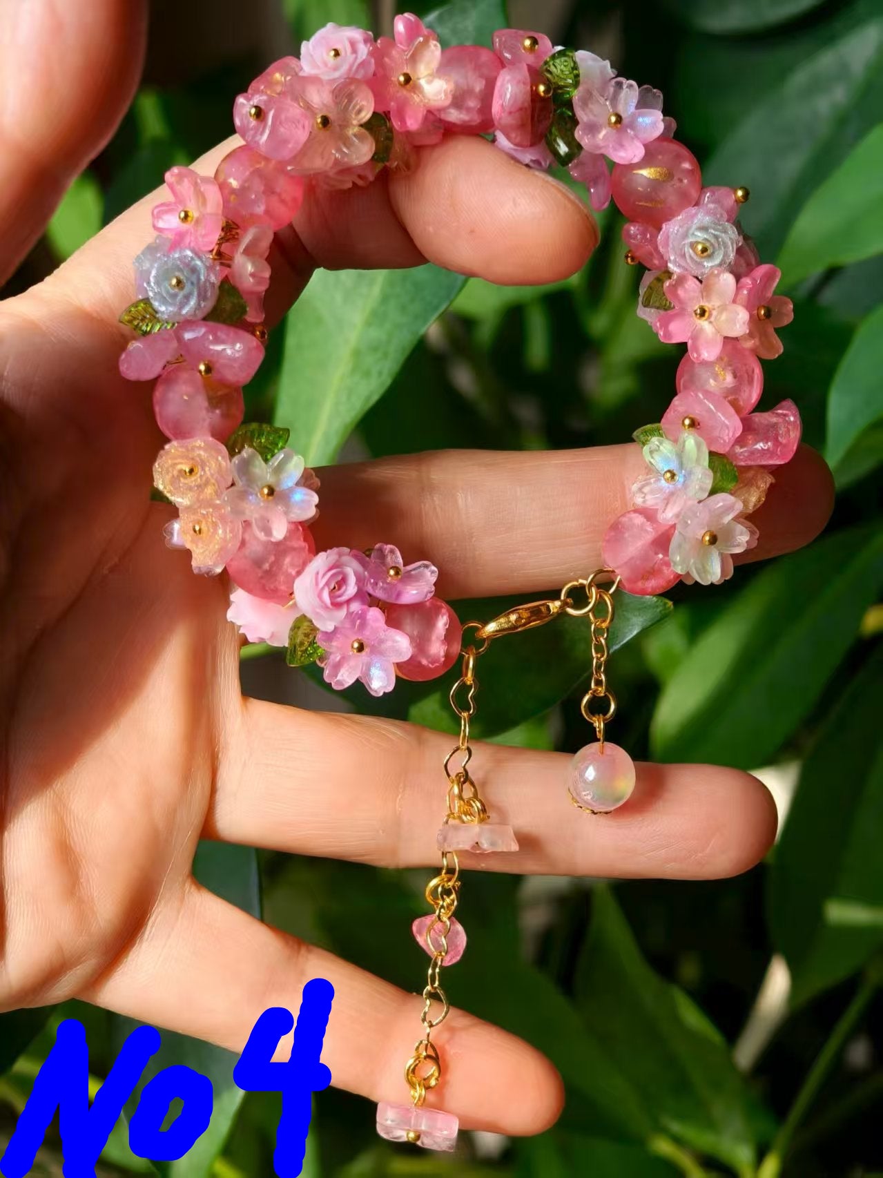 HandMadeBracelet-This pink flower sea bracelet features delicate resin flowers;