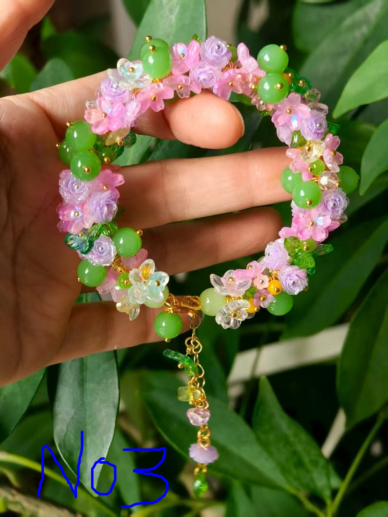 HandMadeBracelet-This pink flower sea bracelet features delicate resin flowers;